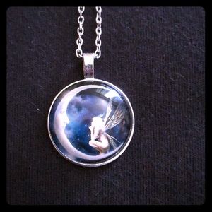 Silver fairy looking at the moon necklace.